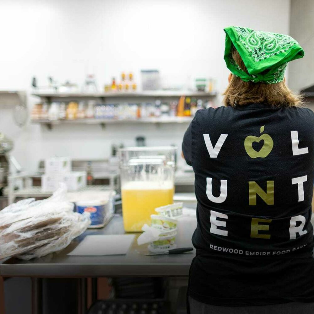 Exchange Bank employee volunteer in the kitchen at Redwood Empire Food Bank, Sonoma County.