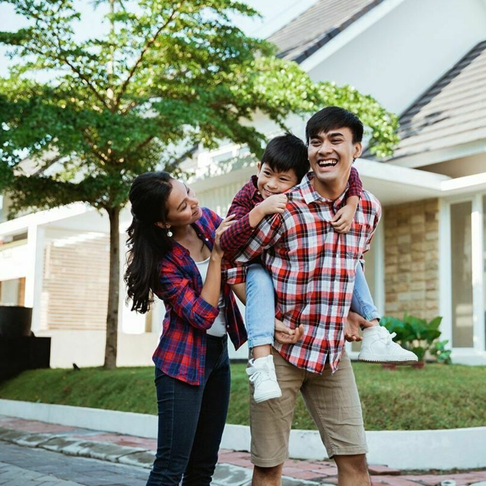 Young Exchange Bank customer couple with child on Dad's back outside of home in Sonoma County.