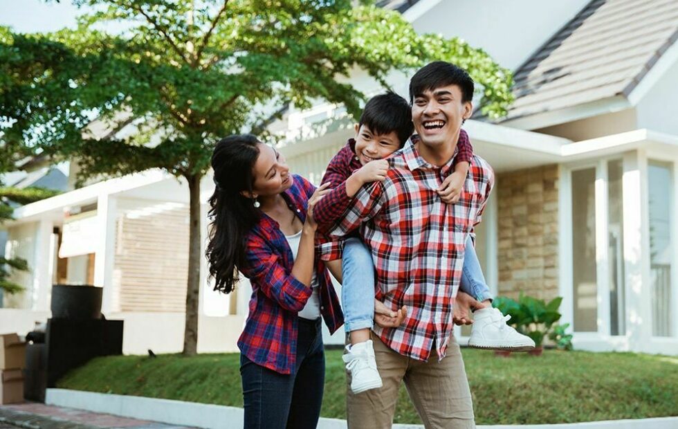 Young Exchange Bank customer couple with child on Dad's back outside of home in Sonoma County.